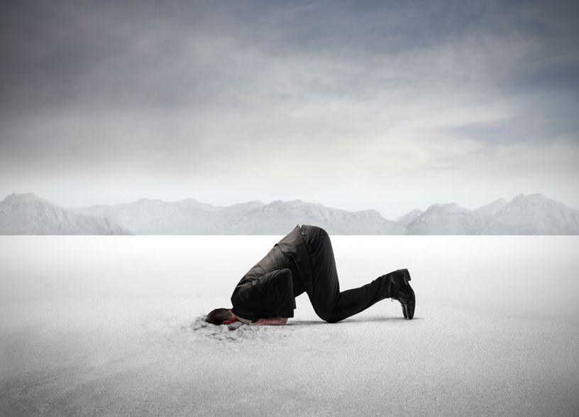 man with head in sand